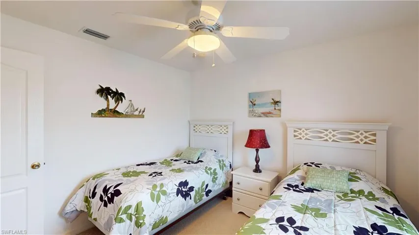Carpeted bedroom featuring ceiling fan