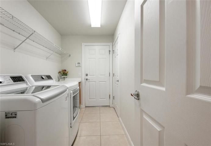Separate laundry room with a Doorway to the garage