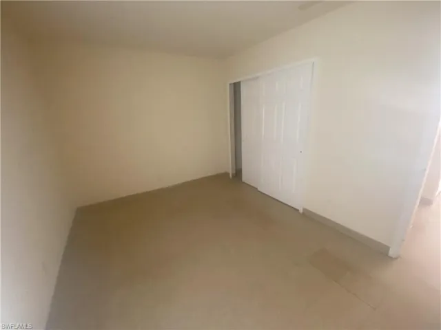 Unfurnished bedroom featuring a closet and baseboards
