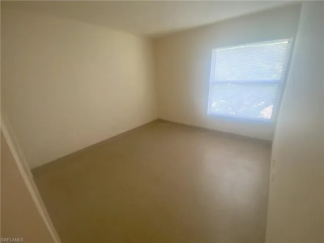 Empty room featuring baseboards