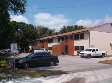 View of property featuring uncovered parking