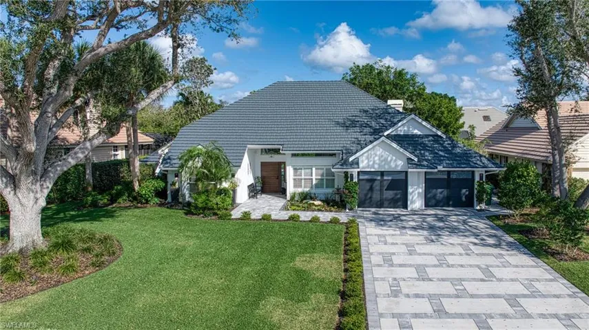 View of front of home featuring a front lawn and a garage