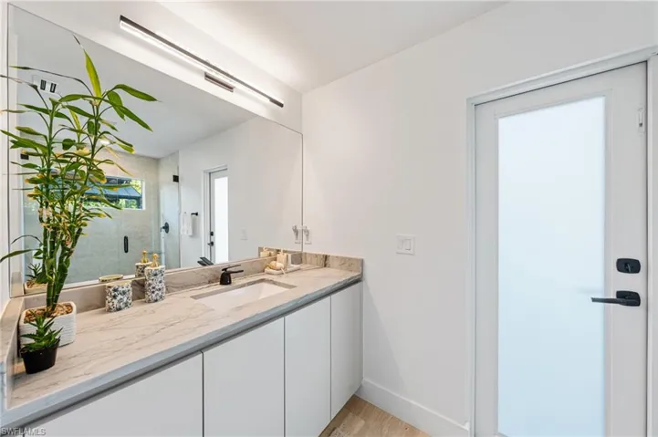 Bathroom with vanity and a shower with shower door