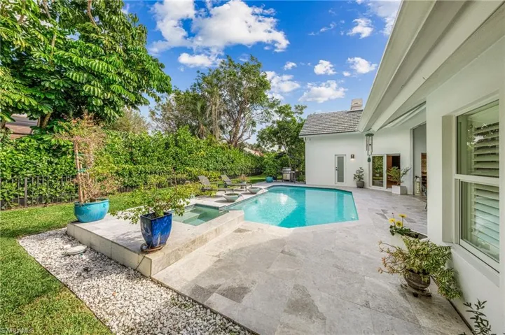 View of pool with an in ground hot tub and a patio area