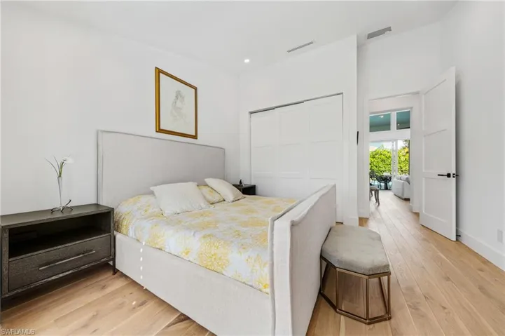 Bedroom with light hardwood / wood-style flooring and a closet