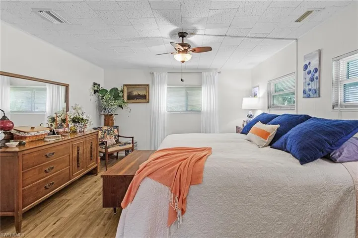 Bedroom with light hardwood / wood-style flooring and ceiling fan