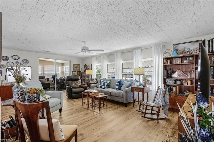 Living room featuring ceiling fan and light hardwood / wood-style flooring