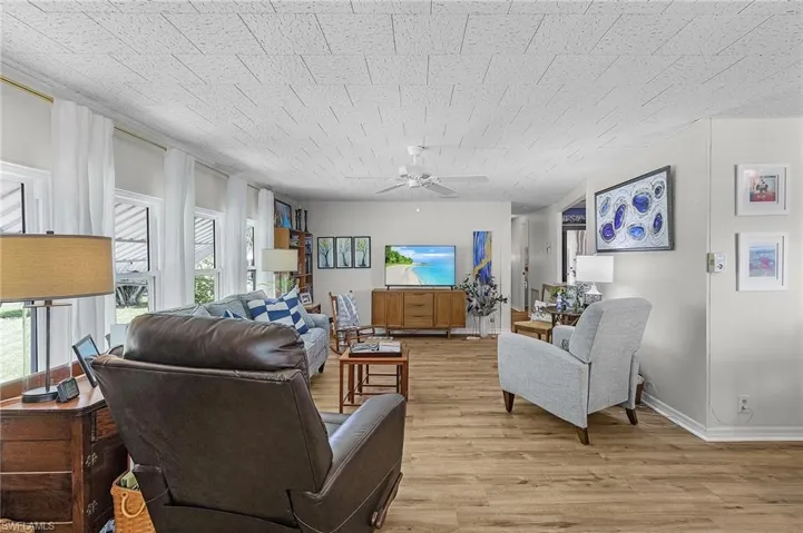 Living room featuring light wood-type flooring and ceiling fan