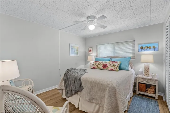 Bedroom with ceiling fan and hardwood / wood-style floors