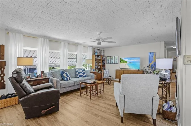 Living room featuring light hardwood / wood-style flooring and ceiling fan