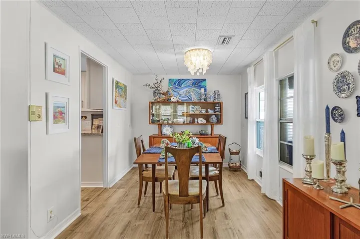 Dining area with a notable chandelier and light wood-type flooring