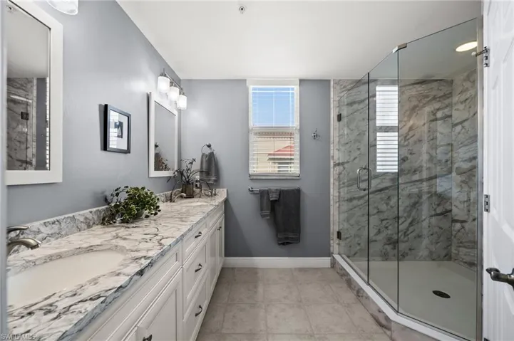 WOW!  What a modern and contemporary bathroom design, walk in shower, and stunning tiles!