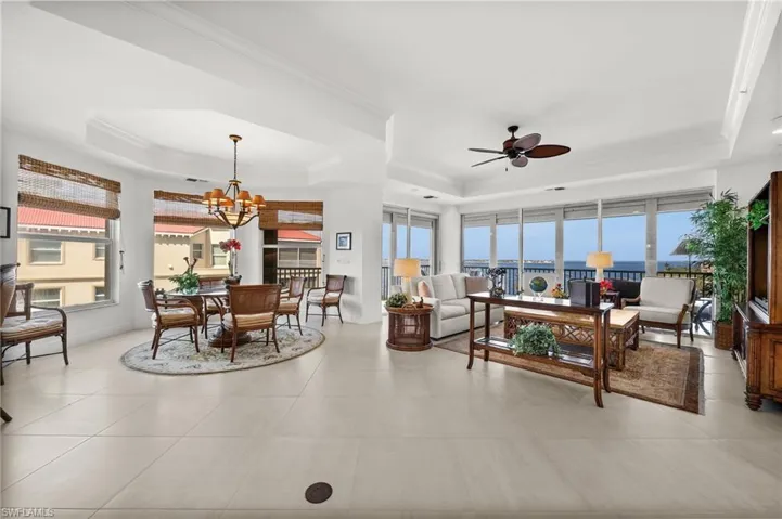 Beautifully tiled living room with most amazing water views, a wrap around lanai, raised ceiling, a wealth of natural light, ceiling fans inside and outside and a very comfortable separate seating/ dining area.  Views views views!