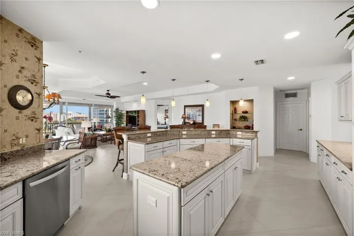 Kitchen featuring white cabinets, a center island, stainless steel dishwasher, and hanging light fixtures and amazing views!
