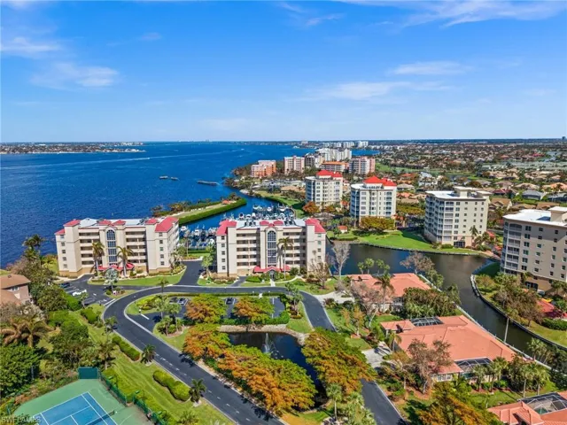 Bird's eye view featuring the tennis courts, the two buildings in front of the beautiful little island!
