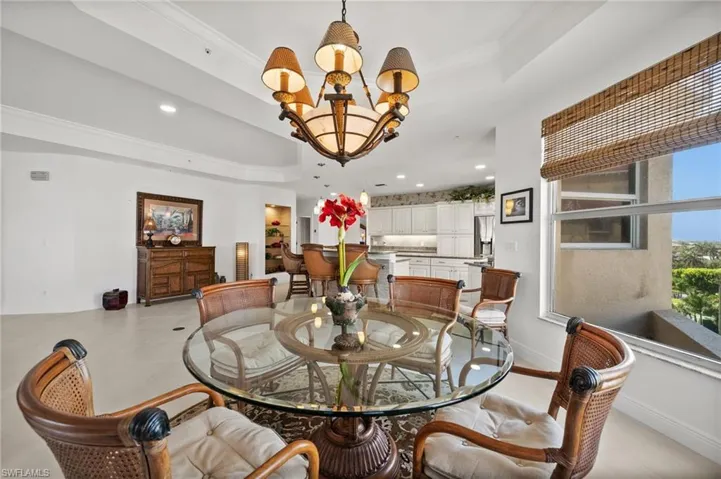 Tiled dining room featuring an inviting chandelier, a tray ceiling, and views views views!