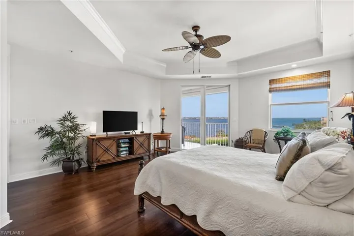 Primary Bedroom reflecting the most amazing water views from your bed over the marina, river and island! Listen to the sound of the waves - how can a bedroom be any better!