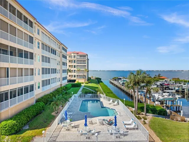 View of swimming pool with a patio area and a water view