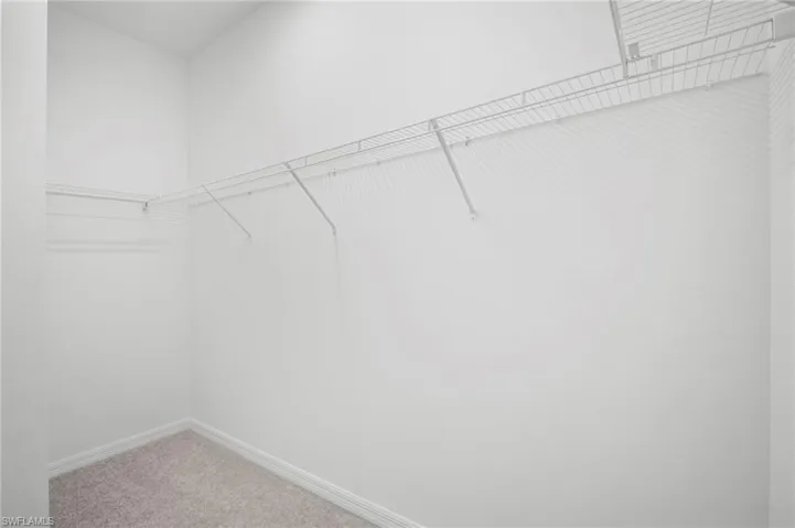 Walk in closet featuring carpet flooring