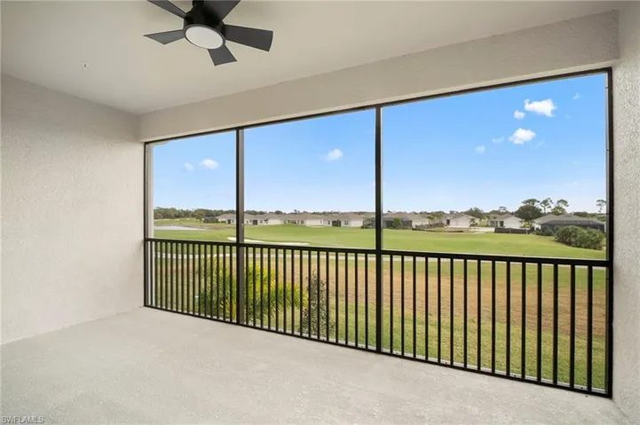 Unfurnished sunroom featuring a residential view and view of golf course