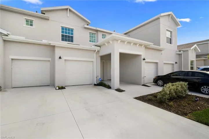 View of front of house featuring driveway, stucco siding, and an attached garage