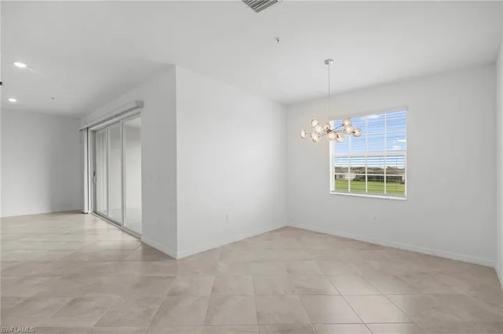 Unfurnished room featuring a chandelier and recessed lighting