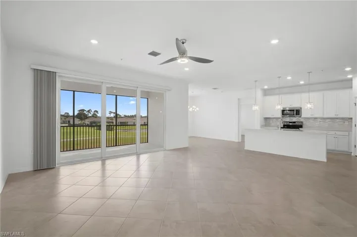 Unfurnished living room featuring ceiling fan, recessed lighting, and light tile patterned flooring
