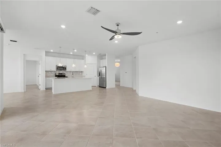 Unfurnished living room featuring recessed lighting and a ceiling fan