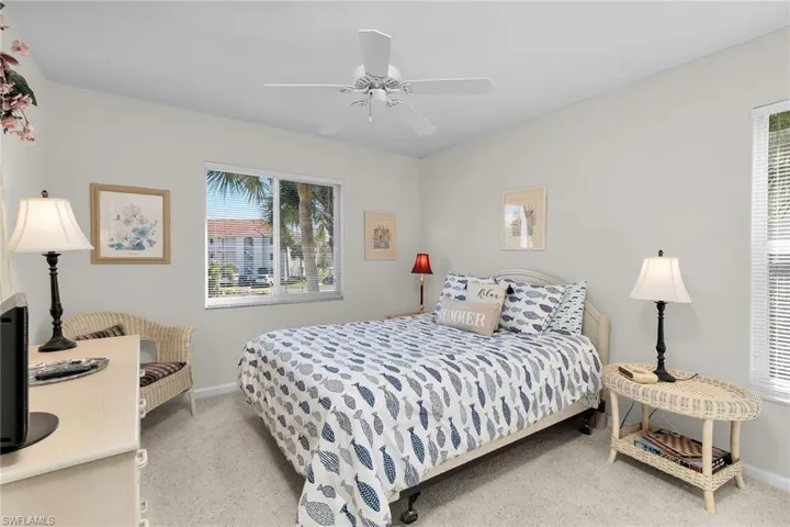 Bedroom featuring light colored carpet and a ceiling fan