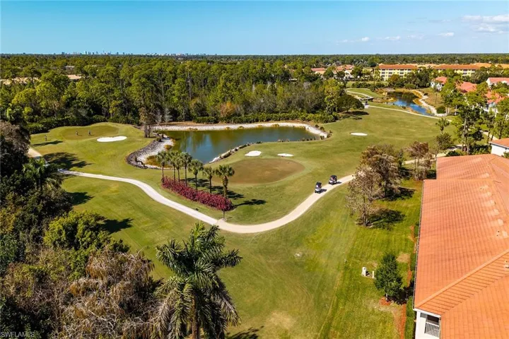 Drone / aerial view of a golf club and a nearby body of water