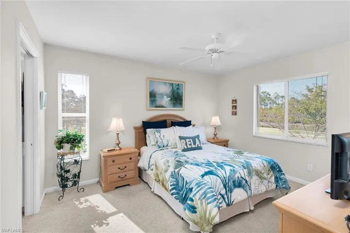 Carpeted bedroom featuring baseboards and ceiling fan