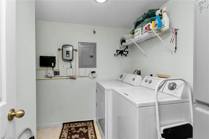 Laundry area with electric panel and separate washer and dryer
