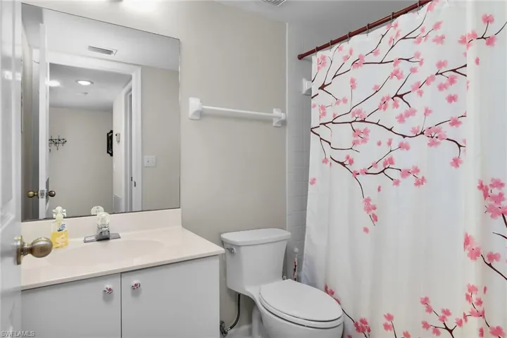 Full bath with a shower with shower curtain and vanity