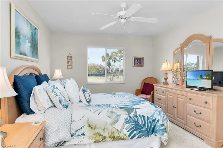 Carpeted bedroom with ceiling fan