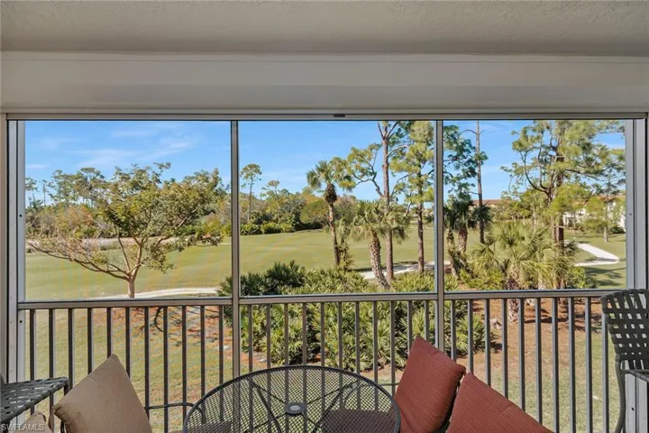 Sunroom with golf course view and healthy amount of natural light