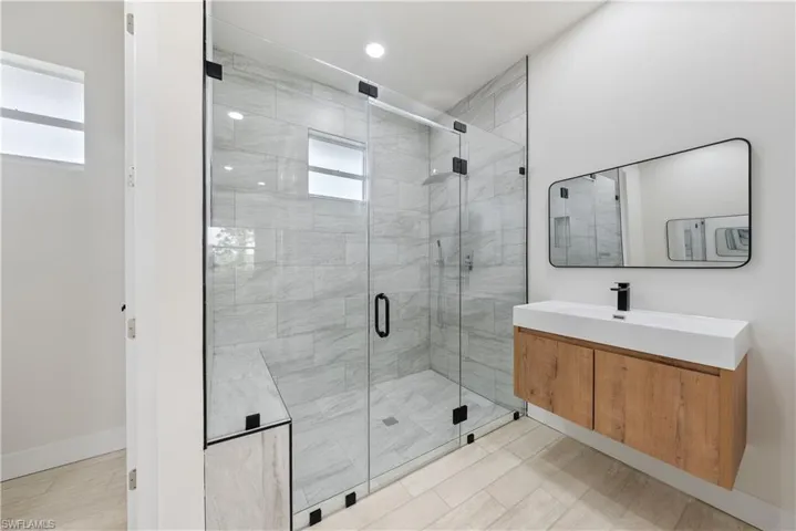Bathroom with vanity and a shower stall