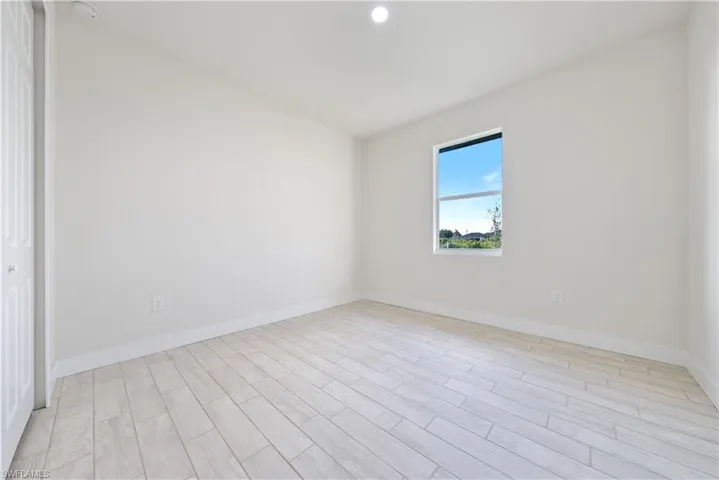 Spare room featuring wood tiled floors and recessed lighting