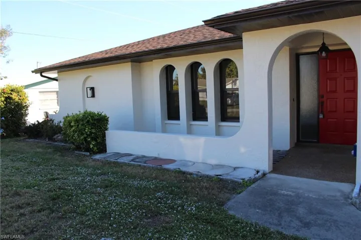 View of side of home featuring a lawn