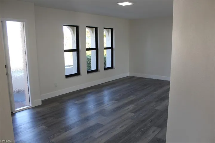 Spare room with dark hardwood / wood-style flooring