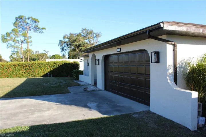 View of property exterior featuring a garage