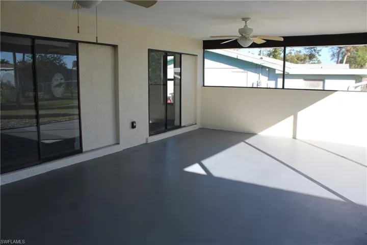 Unfurnished sunroom with ceiling fan