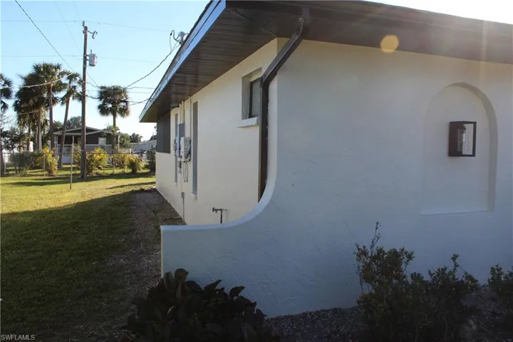 View of property exterior with a lawn