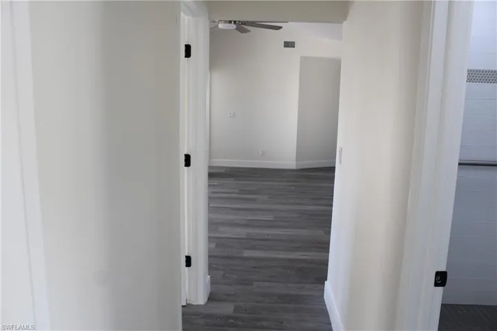Corridor featuring dark hardwood / wood-style floors