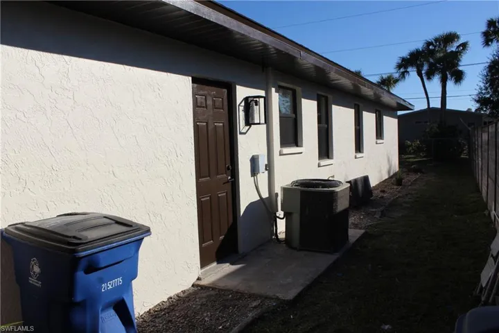 View of side of property featuring cooling unit