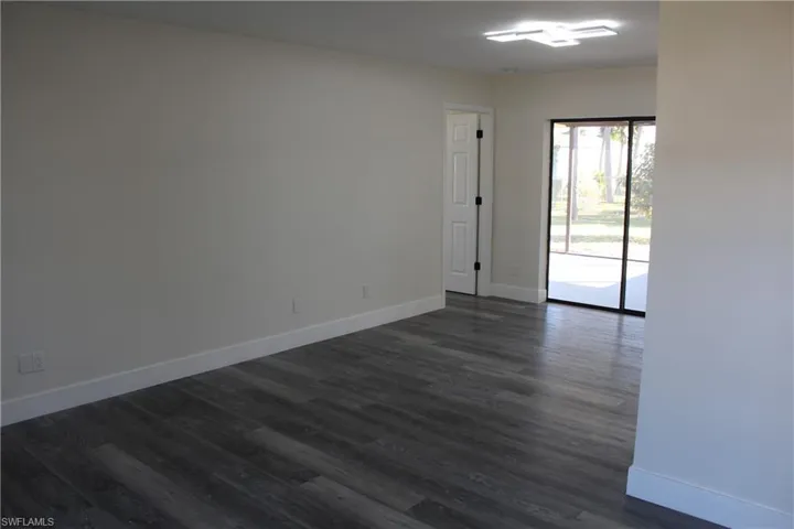 Unfurnished room with dark hardwood / wood-style flooring
