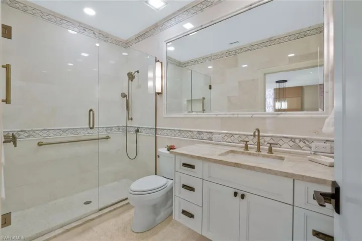 Full Guest Bathroom with Luxurious Stone finishes and design elements