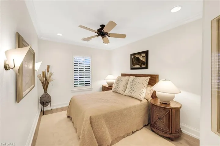 Comfortable Guest Quarters with luxurious Boyd Sconces, crown molding and plantation shutters