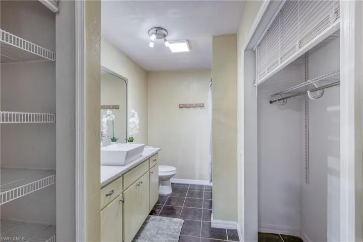 Bathroom featuring vanity, toilet, and tile patterned floors
