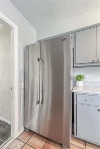 Kitchen featuring high end refrigerator