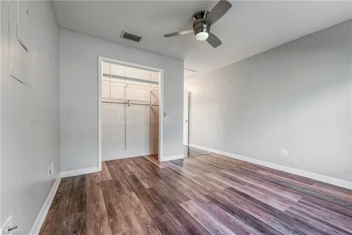 Unfurnished bedroom with ceiling fan, a closet, and hardwood / wood-style flooring